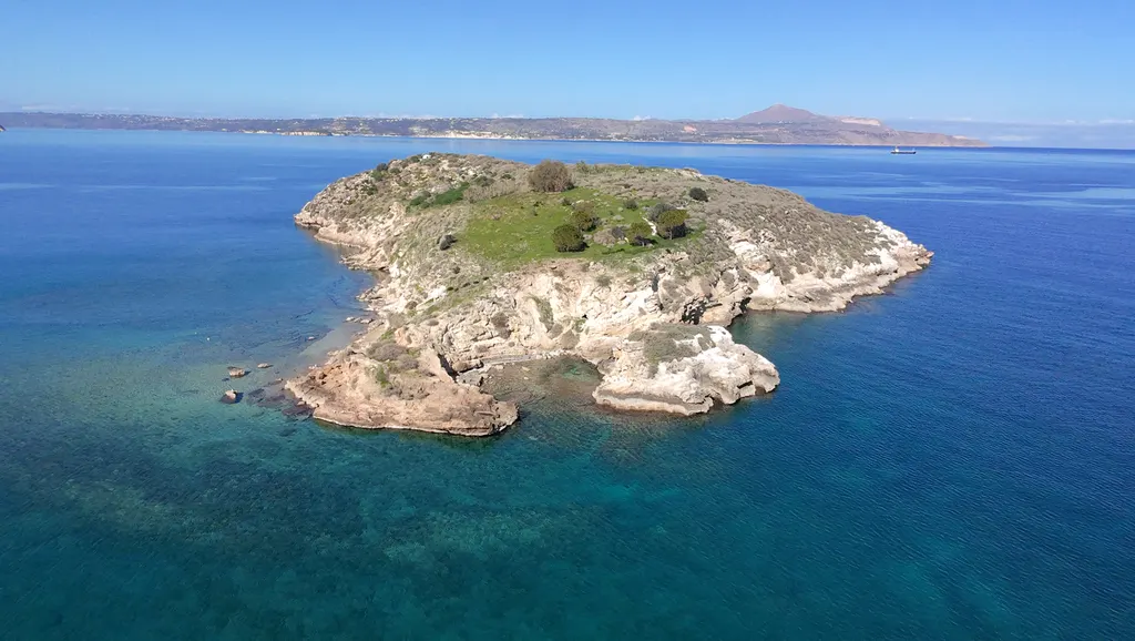 Charming coastal view of Karga island, featuring traditional village architecture and turquoise Mediterranean waters.